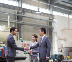 Business people shaking hands in the factory