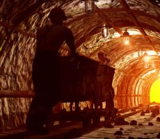 Workers pushing the cart in the mine.